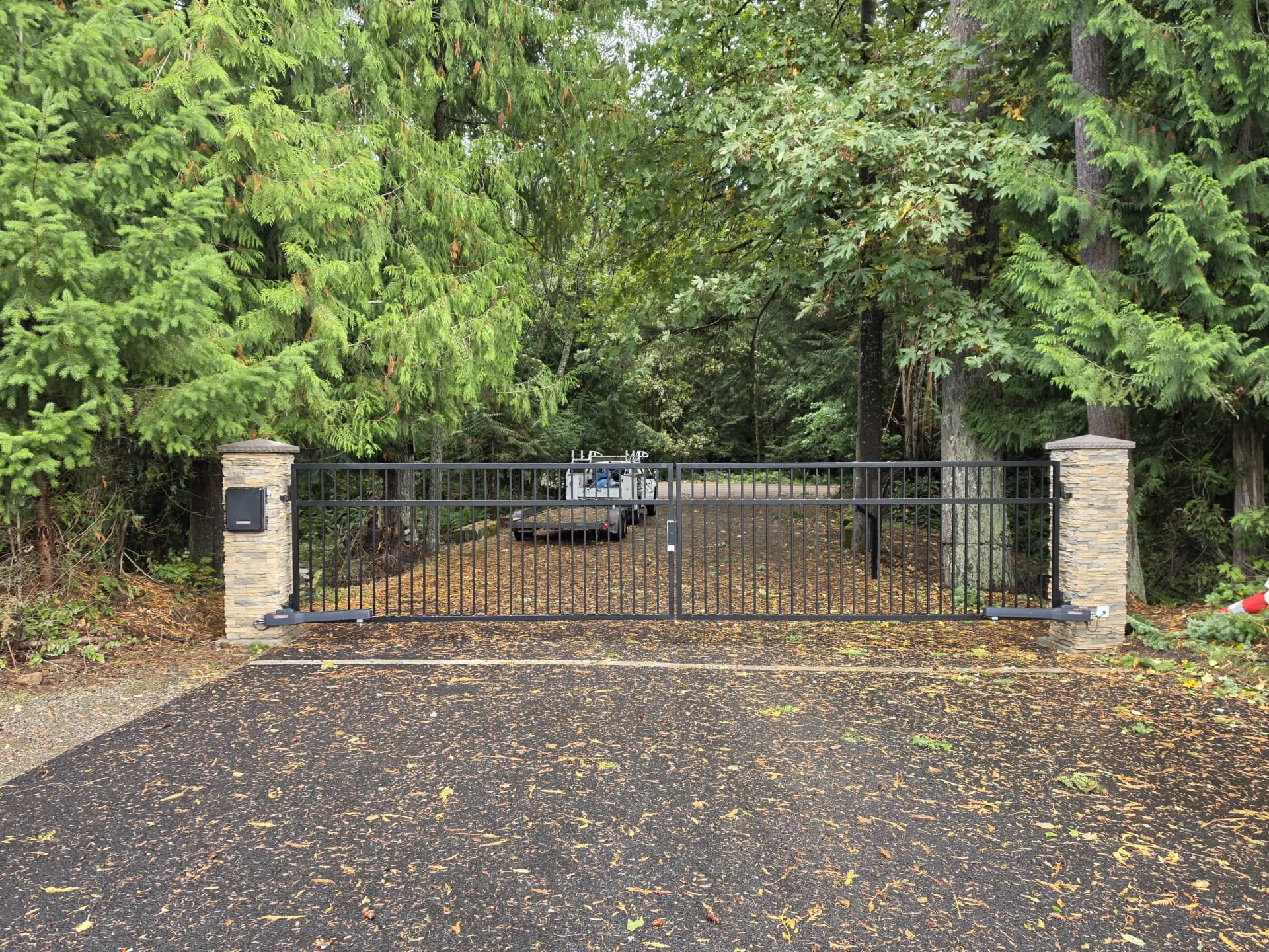 Custom Automatic Driveway Gate with Stone Column Entry image